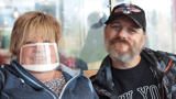 Trevor and his support worker Jayne smiling at the camera. Jayne is wearing a mask. 